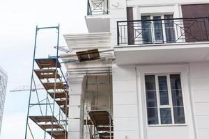 Extensive scaffolding providing platforms for work in progress on a new apartment block UK photo