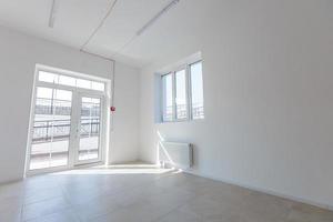 Office extension that uses bricks as a wall, construction, improvement. Interior of small room with window and bricks walls renovation, extension, overhaul and reconstruction. photo