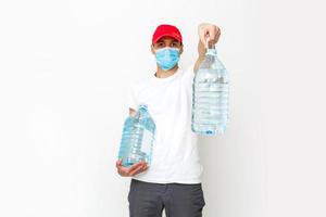 Strong water delivery man in protective mask. Isolated on white. photo