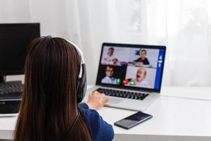 Pretty stylish schoolgirl studying homework math during her online lesson at home, social distance during quarantine, self-isolation, online education concept, home schooler photo