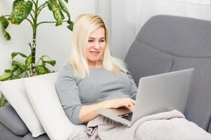 Coronavirus. Young business woman working from home wearing protective mask. Business woman in quarantine for coronavirus wearing protective mask. Working from home. photo