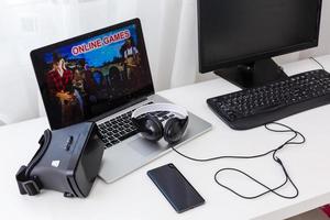 Midsection of young man playing action game on laptop at home photo