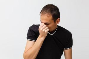 Close-up of a young man having a cough photo