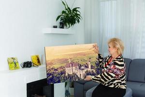 photo canvas. Blonde elderly woman feeling motivated while taking photo canvas