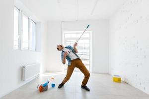 portrait of man with cleaning equipment cleaning the house photo