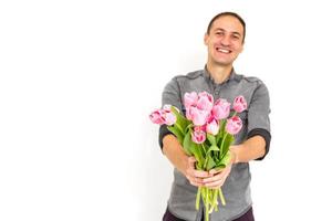 Man with flowers. Romantic Man with bouquet of tulips for birthday. Happy woman's day. Giving bouquet of flowers. Handsome man giving flowers. White background. Horizontal photo.s photo