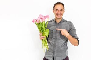 Man with flowers. Romantic Man with bouquet of tulips for birthday. Happy woman's day. Giving bouquet of flowers. Handsome man giving flowers. White background. Horizontal photo.s photo