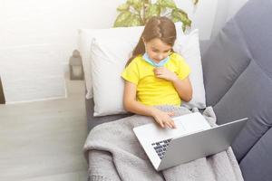 Coronavirus home school concept, quarantine. Girl doing homework. Modern lifestyle photo