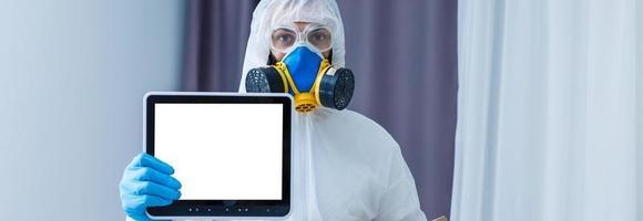 Man in chemical protective suit on background. Virus research photo