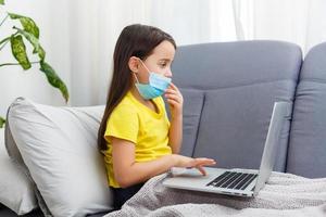 Coronavirus home school concept, quarantine. Girl doing homework. Modern lifestyle photo