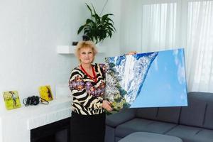 photo canvas. Blonde elderly woman feeling motivated while taking photo canvas