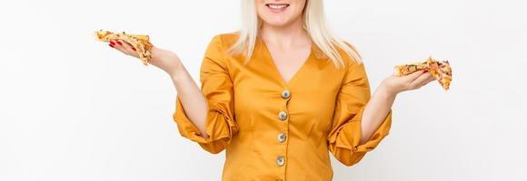 Happy young woman eating slice of hot pizza, isolated on white photo