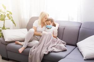 Sleepy little child with mom - shallow DOF, focus on little girl's eyes photo