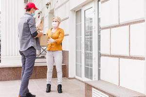 food delivery man in protective mask photo