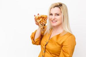 Happy young woman eating slice of hot pizza, isolated on white photo