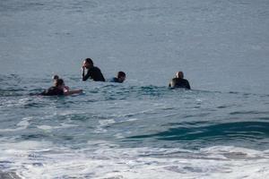 young athletes practising the water sport of surfing photo