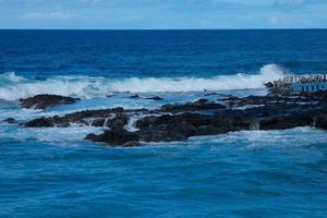 Large waves crashing against the rocks in the ocean photo