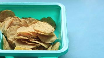 a bowl of chips and salsa on table , video