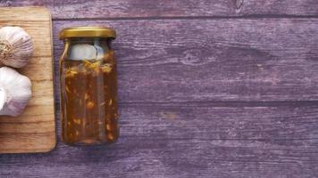 Homemade Garlic Pickle in a glass jar on table , video