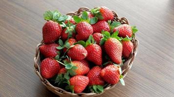 hand pick a fresh strawberry in a bowl on table video