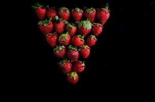 Strawberries on black background photo