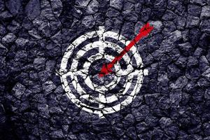 Target figure on broken wall, concept of achieving goal quality, Aim Target Red Symbols of goals and objectives over grunge background. business idea photo