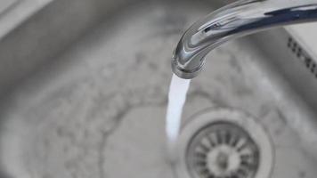 water pouring from a faucet tap slow motion video