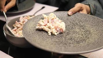 plate of cream and herb pasta on table video