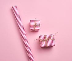 two gifts wrapped in pink striped paper, top view photo