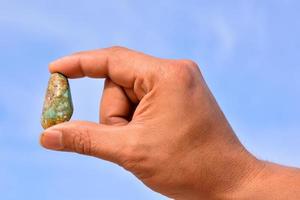 Holding small gemstone photo