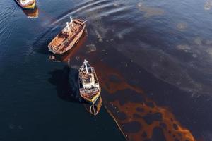 Oil leak from Ship , Oil spill pollution polluted water surface. water pollution as a result of human activities photo