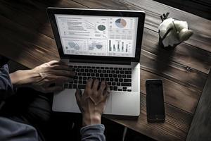 Web analytics and digital marketing. Top view of business man using laptop photo