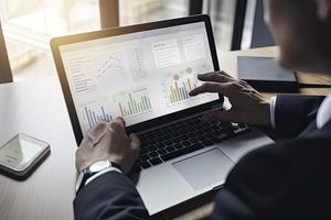 Web analytics and digital marketing. Top view of business man using laptop photo