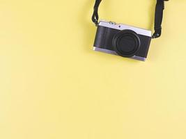 flat lay of digital camera on yellow  background with copy space. Photo and memory concept.