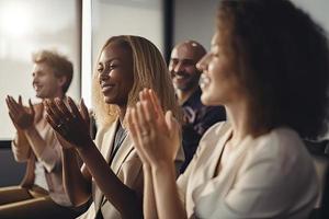 Cropped shot of an unrecognizable diverse group of businesspeople applauding while sitting photo