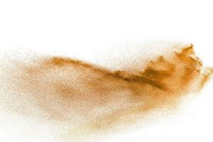 Brown sand explosion isolated on white background. Abstract sand cloud backdrop. photo
