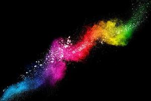 Pastel color dust particle splashing.Colorful powder explosion on black background. photo