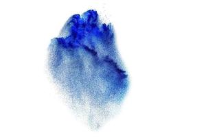 Splash of blue colored powder. Blue powder particles splatter on white blackground. photo