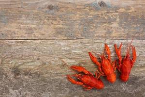 Crawfish on the old wooden background. Top view. photo