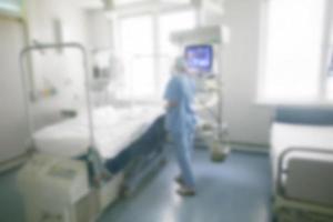 Blurred background of a hospital room with a silhouette of a doctor. photo