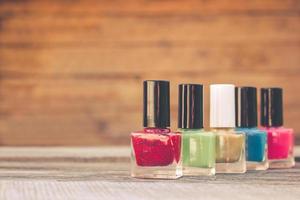 Nail polish on the old wooden background. photo