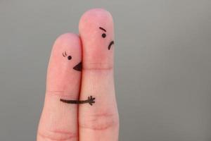 Finger art of couple. Woman kisses man, she don't like him. Concept is not shared love. photo