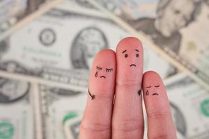 Finger art of displeased family on background of money. Concept of poor people. photo