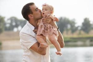 Happy dad plays with his little daughter for a walk. Paternity. photo