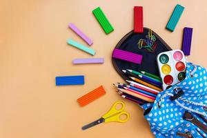 School supplies fall out of backpack. Top view. photo