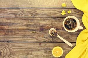 Tea with herbs, lemon, medicine. Top view. Toned image. photo