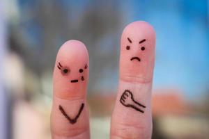 Finger art of family during quarrel. Concept of husband beat his wife. Woman has a black eye. photo