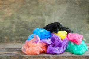 Different plastic bags on wooden background. photo