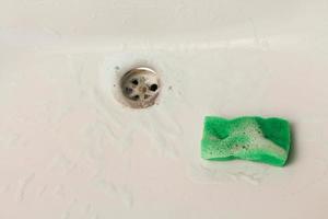 Sponge and detergent in sink. photo