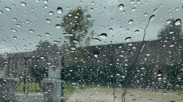 Raindrops falling on the windshield of the car video